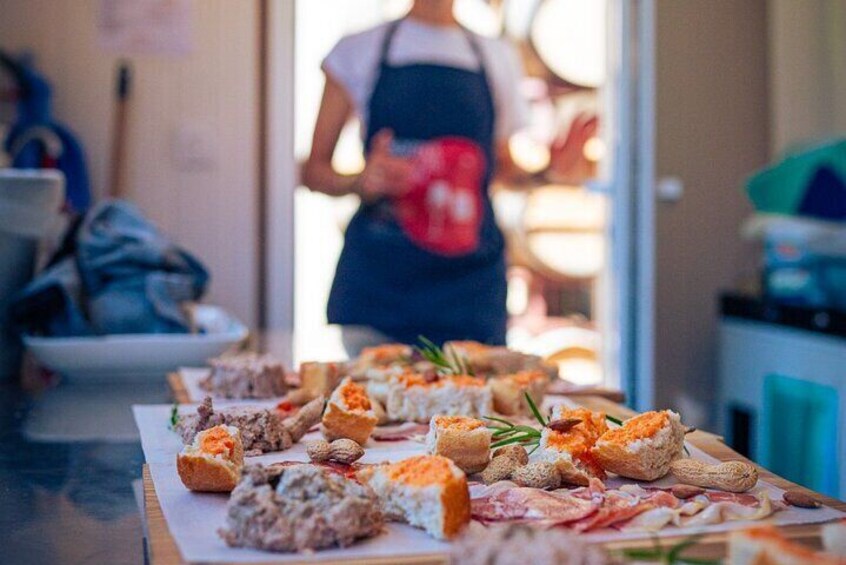 A table with various food items, including sandwiches and pastries, in a cafe setting. 2
