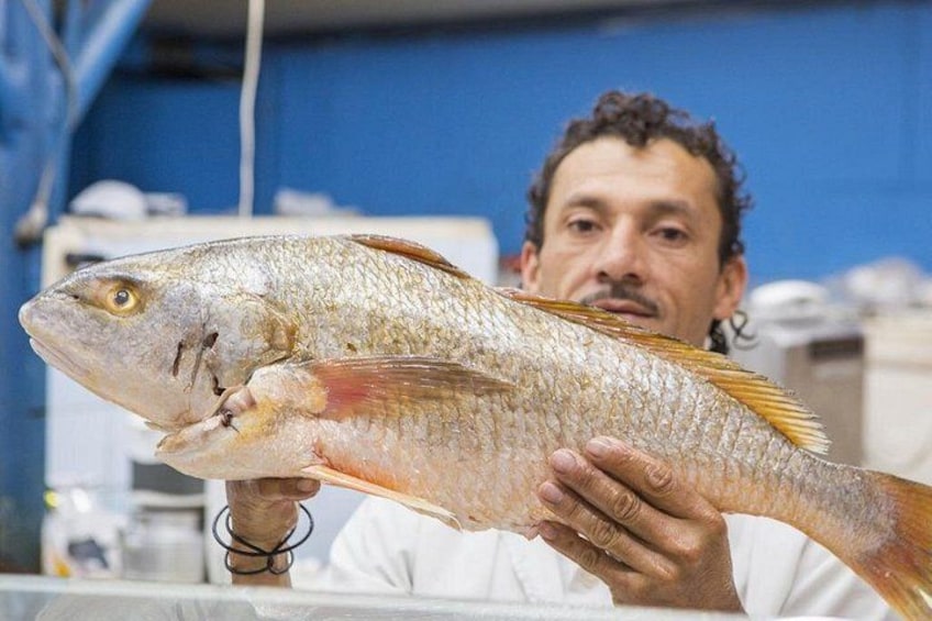 A person holding a fish. 3