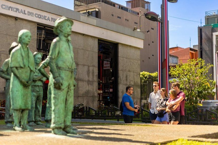 A statue of three figures in front of a building labeled 'CENTRAL DE CONCEPCION.' 2