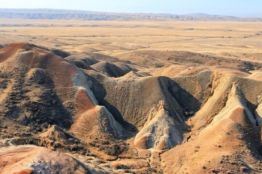 A vast desert landscape with rolling hills and valleys. 3