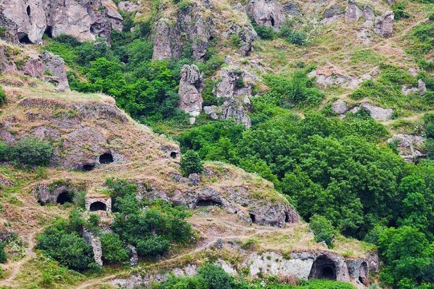 A mountainous landscape with rocky outcrops and green vegetation. 5