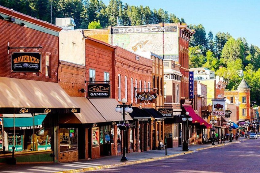A street lined with historic buildings, including a Maverick's Steakhouse and a gaming establishment. 5