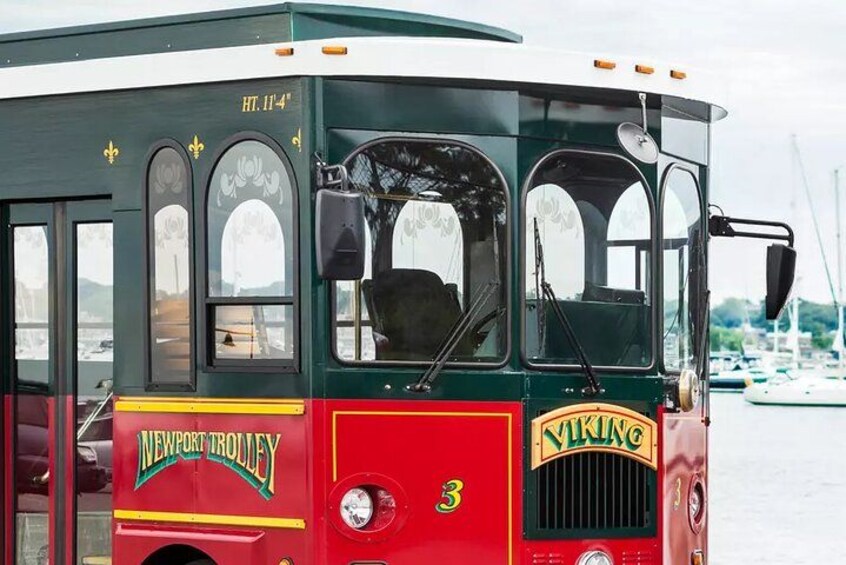 En ældre sporvogn med 'Newport Trolley' og 'Viking' logoer, nummer 3, og et grønt og rødt farveskema. 5