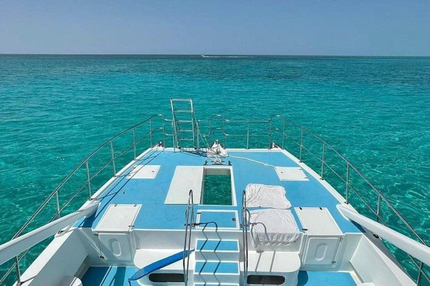 A boat deck with a ladder, railings, and a covered area with a white canopy. 4