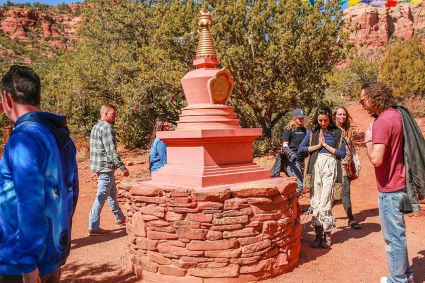 A red stupa surrounded by tourists. 3