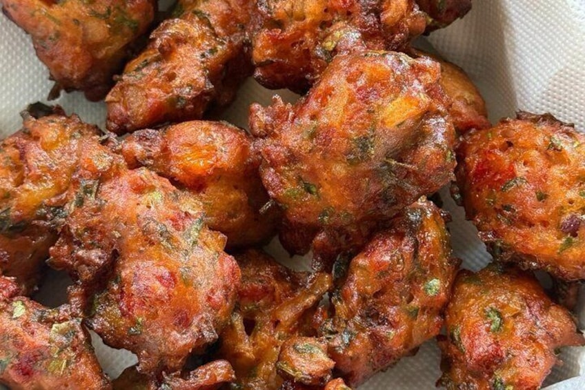 A close-up of fried chicken pieces with a crispy, seasoned coating. 5
