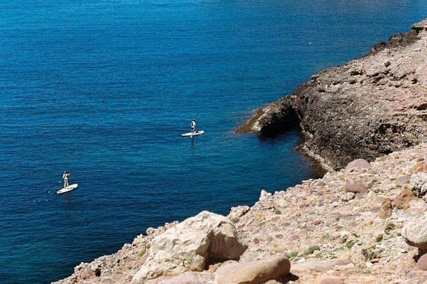 A rocky coastline with clear blue water. 4