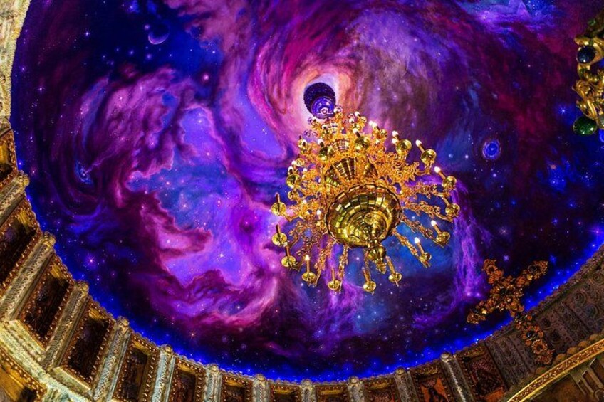 A celestial-themed mural with a central golden ornament. 2
