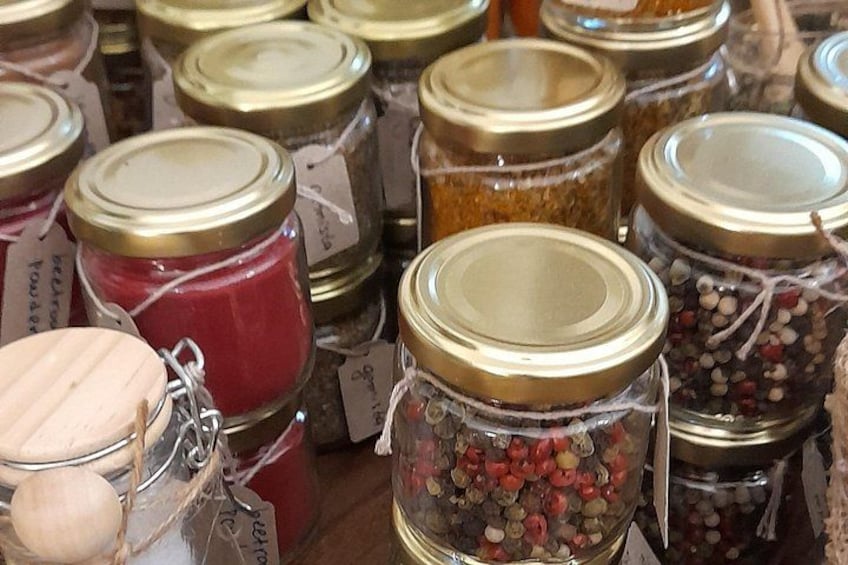 A variety of glass jars with metal lids, some containing spices and herbs, and others with labels. 5