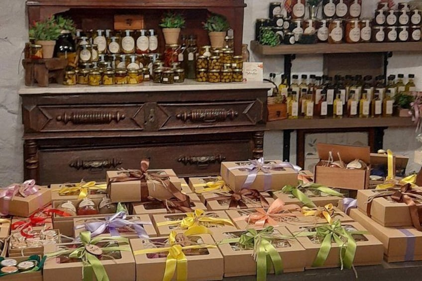 A store with various gift boxes and shelves of bottles. 4