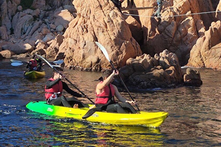People kayaking on a river with rocky banks. 1