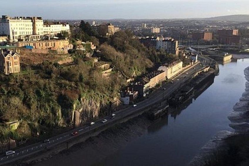A river with a bridge, buildings, and a highway. 4