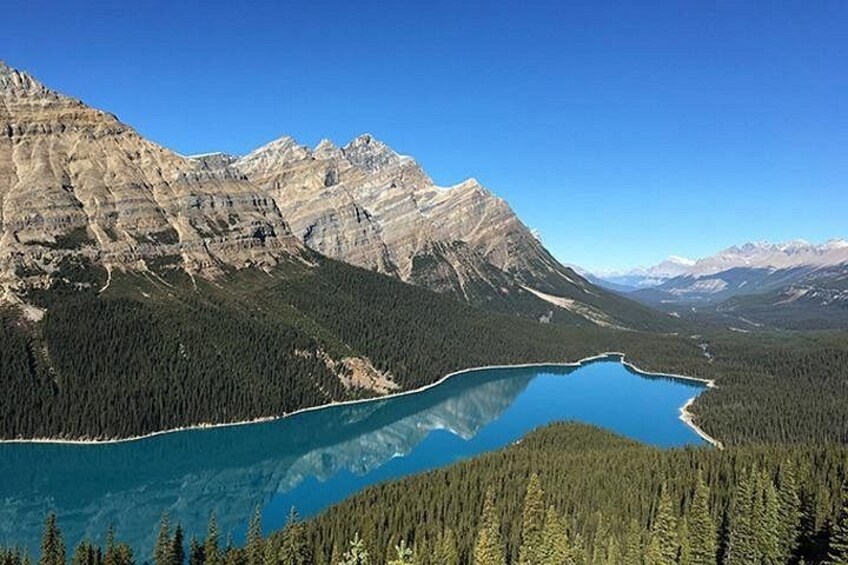 A mountain range, a lake, and dense forest. 3