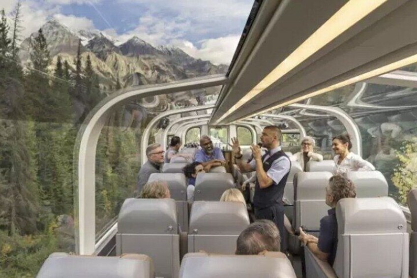 A modern train with passengers and a scenic mountain view. 5