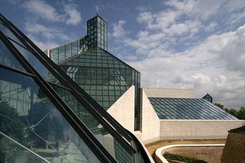 A modern building with a glass facade and a unique geometric design. 5