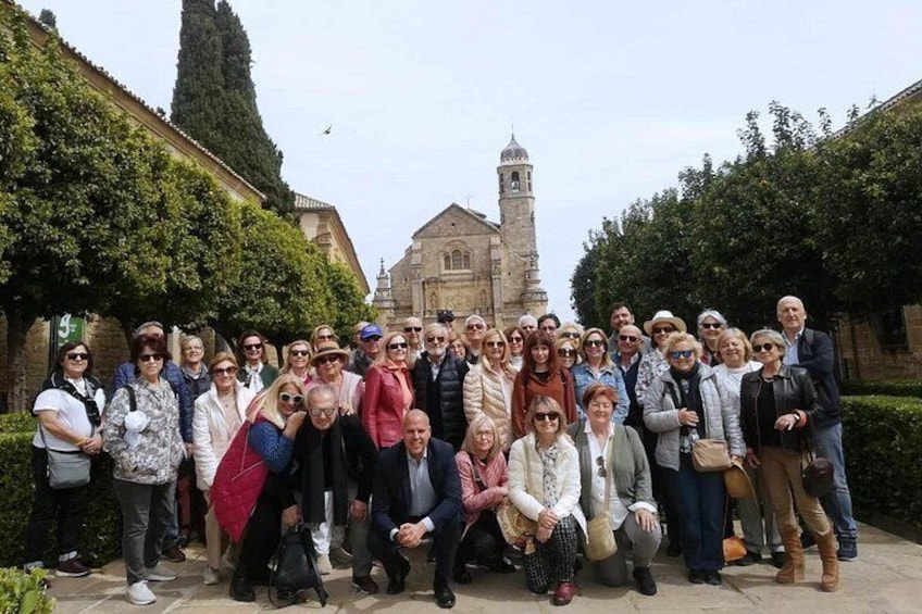 Un groupe de personnes posant devant un bâtiment historique doté d’un clocher. 2