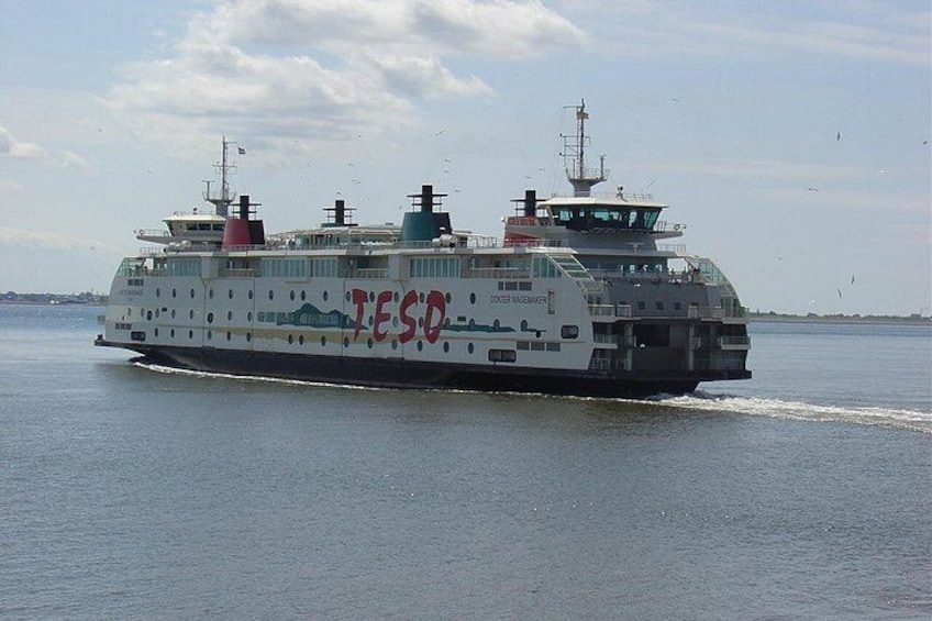 A large ferry with the name 'TESCO' on its side, sailing on a body of water. 4
