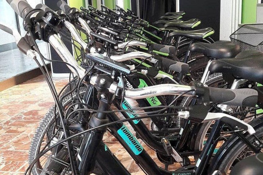 A row of stationary bicycles in a room with a tiled floor. 4