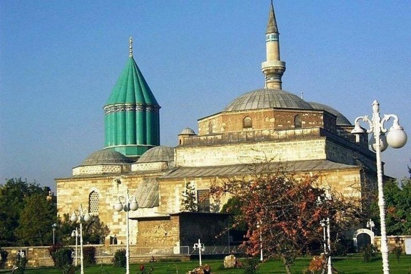 A historic building with a green dome and a minaret. 3
