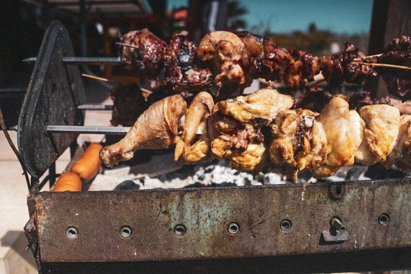 A traditional outdoor grill with skewers of meat and vegetables. 2