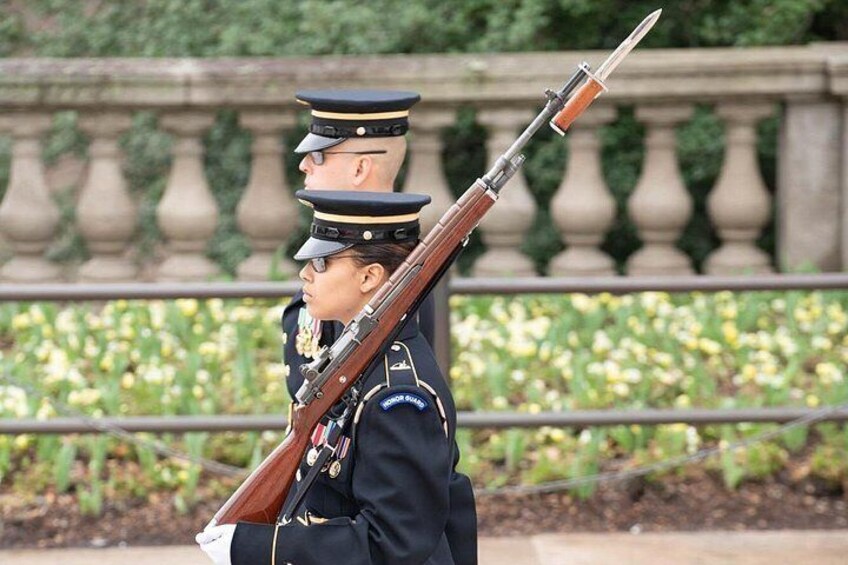 A person in a military uniform carrying a rifle. 4