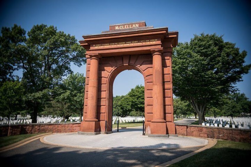 A red archway with the inscription "M. C. CLIFLAN" and a plaque below it. 2