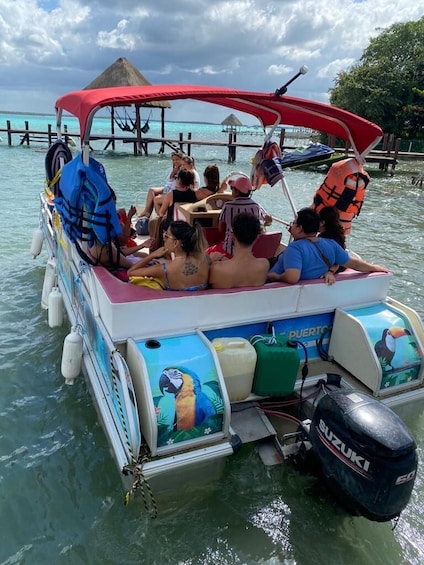 A boat with passengers, a parasol, and a Suzuki outboard motor. 5