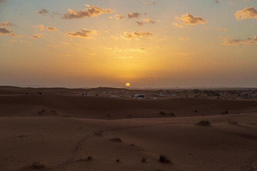 A desert landscape with sand dunes and a sunset. 1