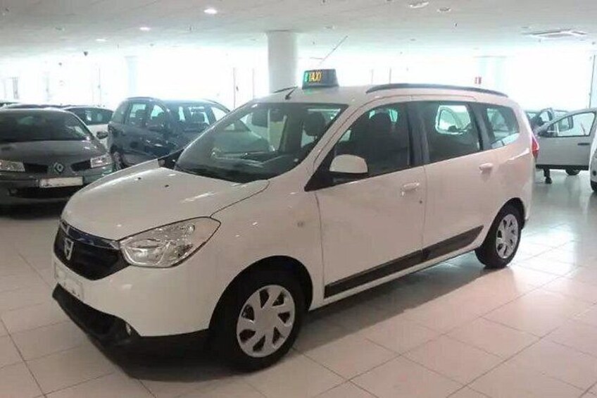A white car in a showroom with other vehicles. 3