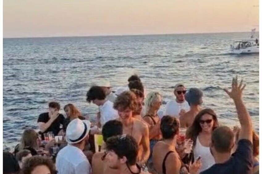 A group of people on a boat at sunset. 5