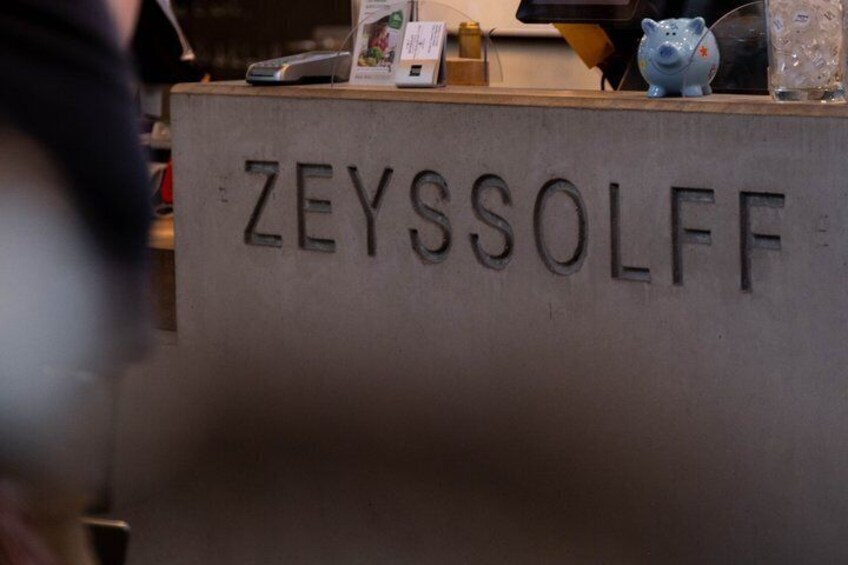 A reception desk with the name 'ZEYSSOLFF' engraved on it. 2