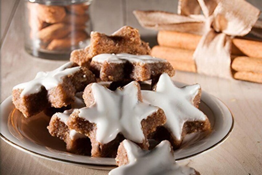 A plate of star-shaped cookies with white icing. 4