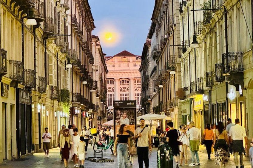 A bustling street with pedestrians, a bicycle, and historic buildings. 3