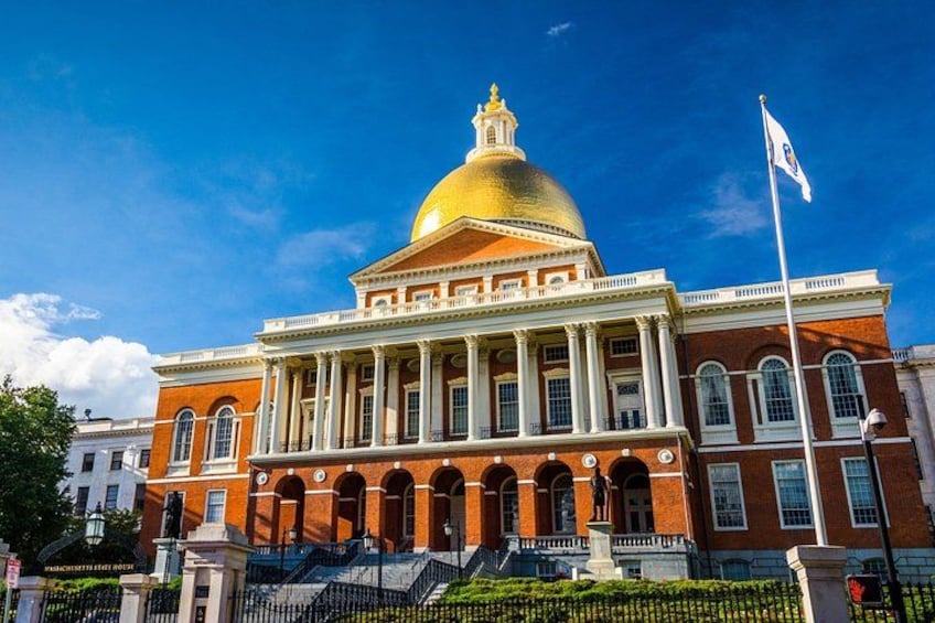 A large brick building with a golden dome and columns. 4