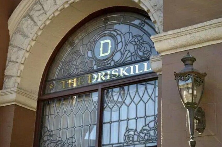 A building entrance with a sign reading 'The Driskill.' 5