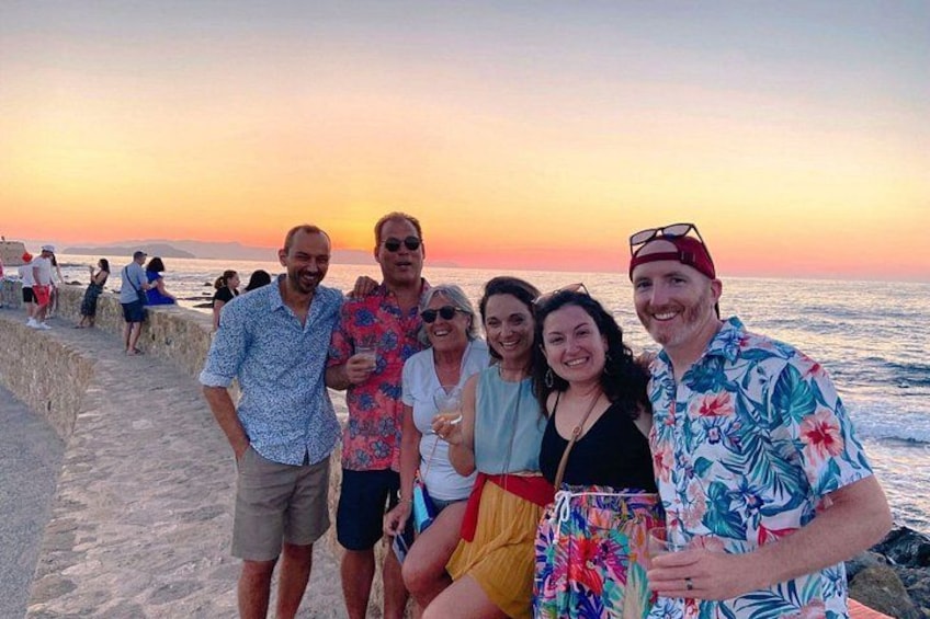 A group of people at a beach during sunset. 2