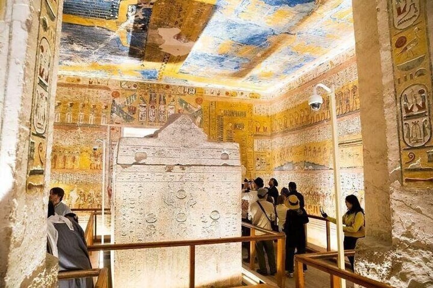 An ancient Egyptian tomb with hieroglyphs and a large sarcophagus. 2