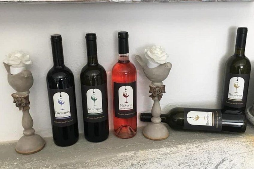 A row of wine bottles on a shelf, each with a unique label and design. 1