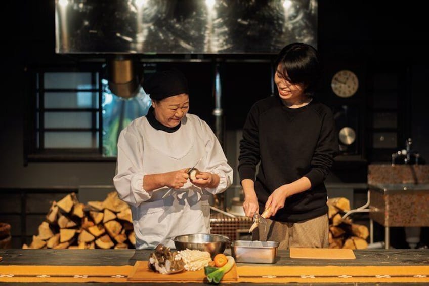 Two people in a kitchen preparing food. 1