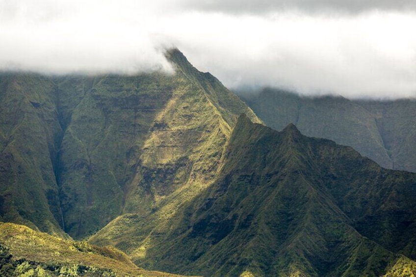 A rugged mountain landscape with steep slopes and a valley. 4