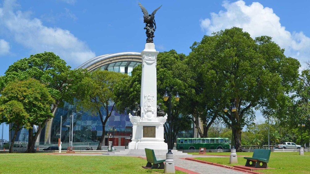 monument in front of a glass building in Trinidad and Tobago