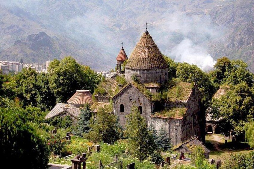 A mountainous village with traditional buildings and a prominent church with a distinctive dome. 3