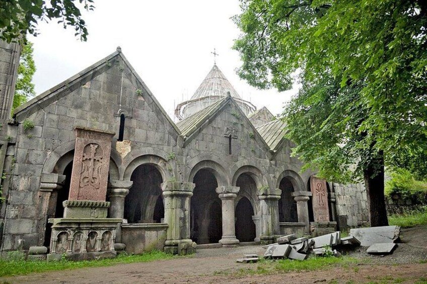 An old stone church with arched doorways and a bell tower. 2