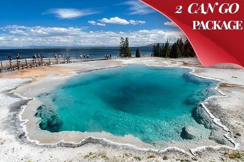 A hot spring with turquoise water surrounded by a rocky landscape and a wooden walkway. 1