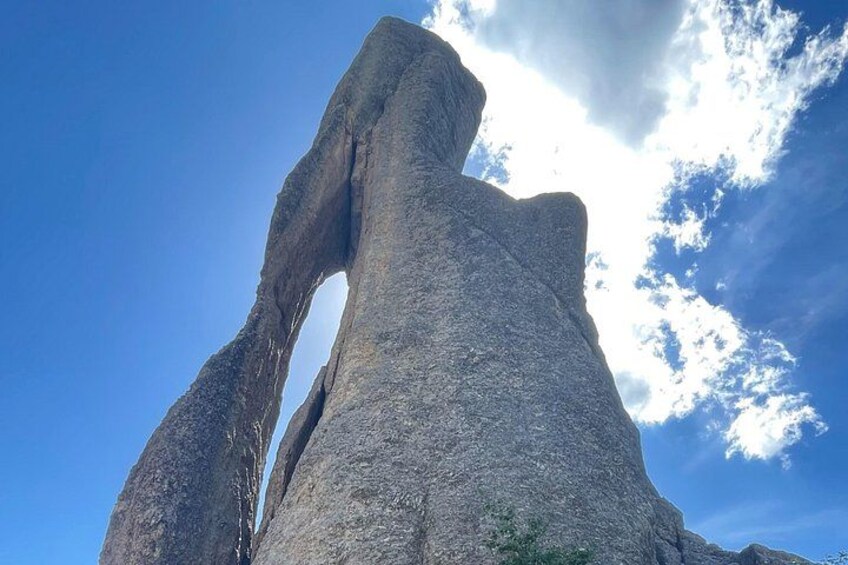 A large rock formation with a natural arch. 4