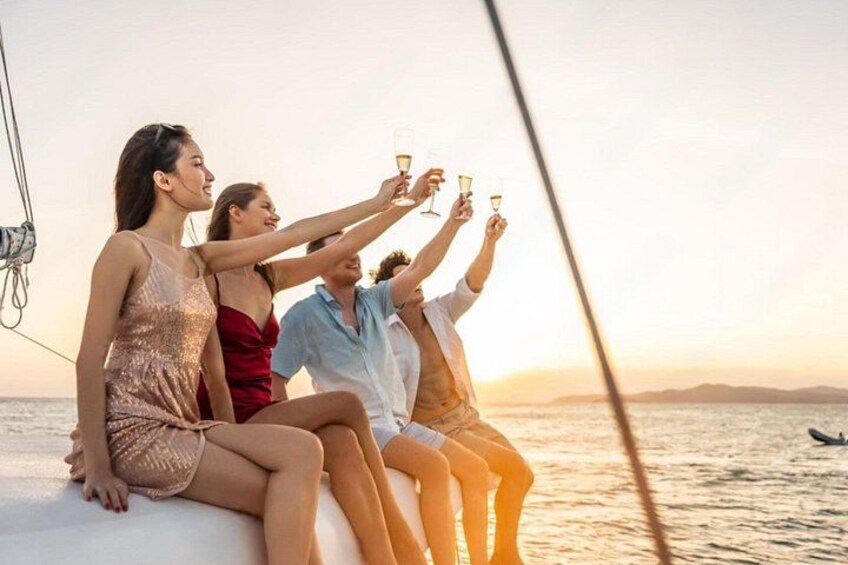 A group of people on a boat, toasting with champagne glasses. 3