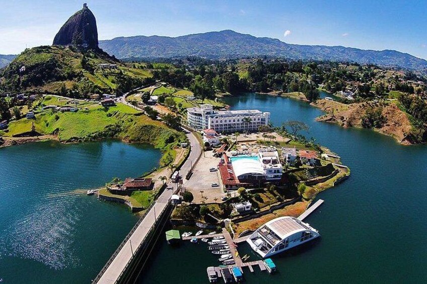A river with a bridge, a large building, and a mountain. 4