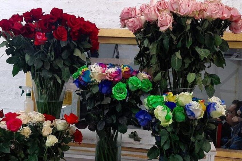 A variety of colorful roses in vases. 2
