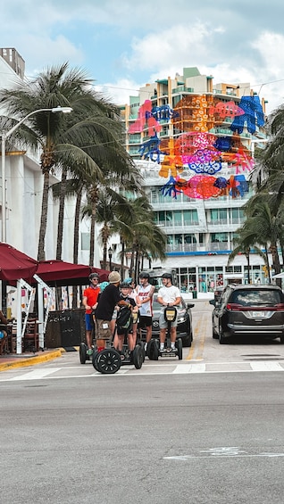 A street with palm trees, a building with colorful decorations, and people on hoverboards. 4