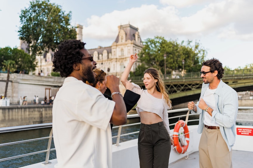 A group of people on a boat with a historic building in the background. 2